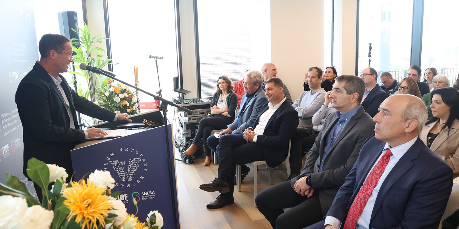 Speaker addressing guests at Cohen Veterans Network and Sheba Medical Center mental health clinic event