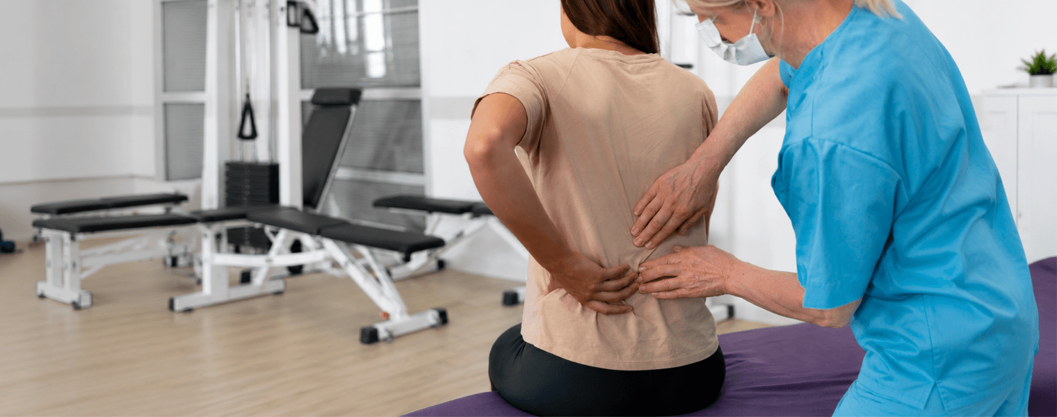 Rehabilitation specialist providing therapy for a patient with spinal cord injury