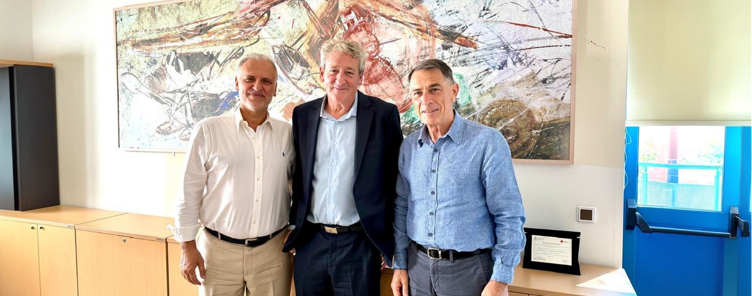 Three representatives standing together during a visit connected to the Sheba–Greece healthcare partnership